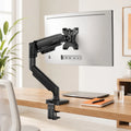 Stando Boom Precision Gas-Spring Monitor Arm on a minimalist home office desk