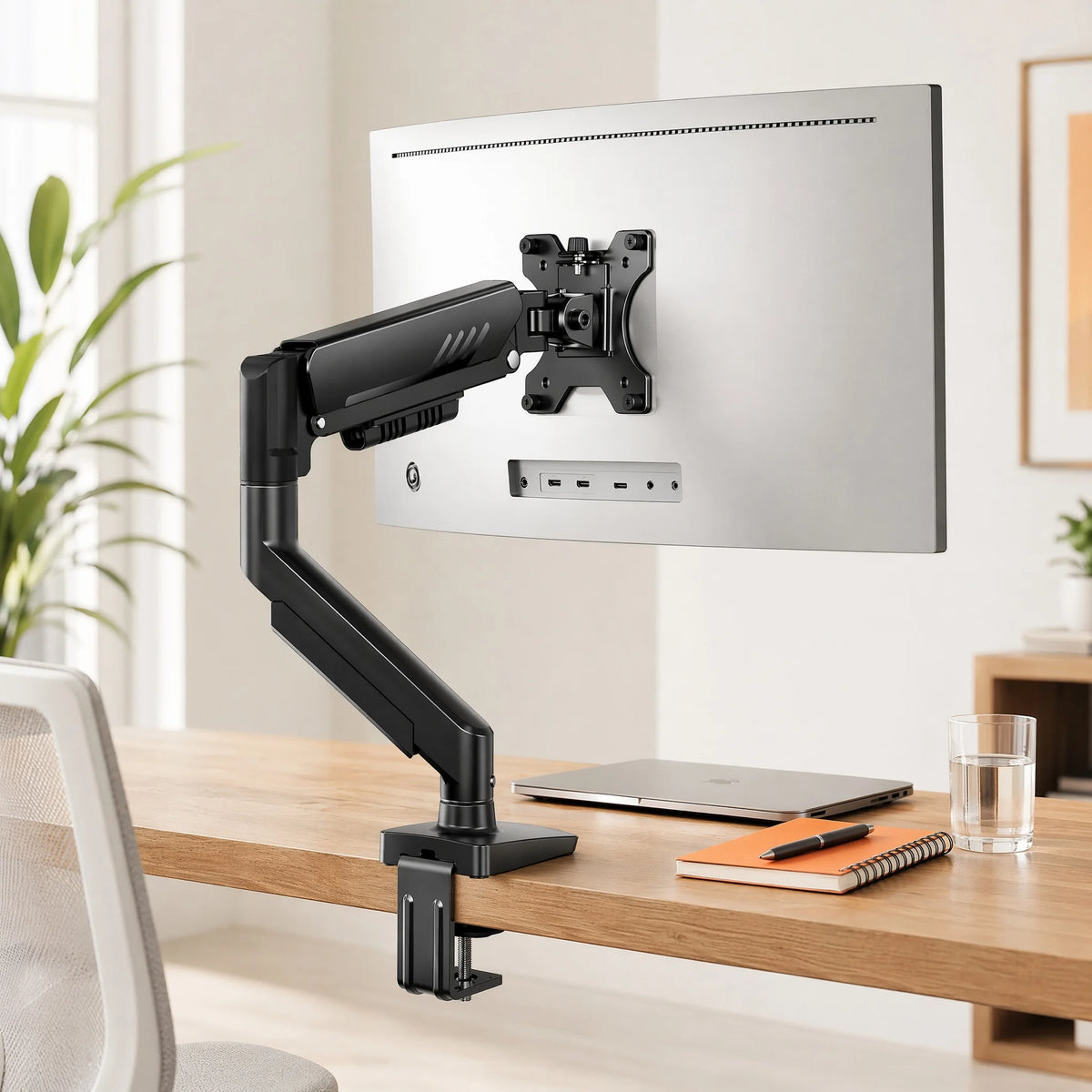 Stando Boom Precision Gas-Spring Monitor Arm on a minimalist home office desk